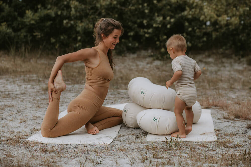 Woman and child doing yoga with organic yoga pillows from Cocoon Company